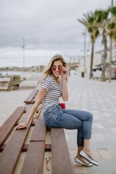 Young woman looking over sunglasses