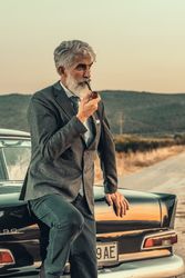 Man in gray smoking pipe beside car outdoor
