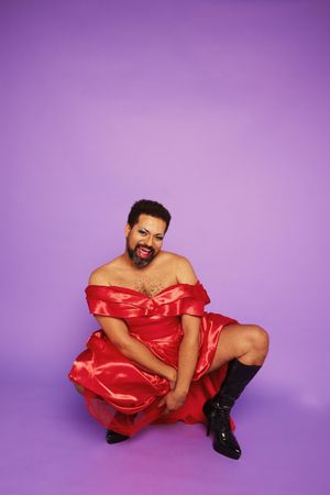 Portrait of a drag queen posing on purple background
