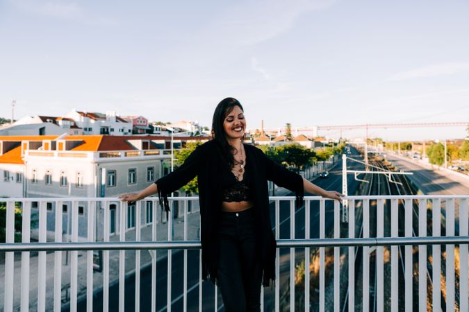Trendy female standing on urban background