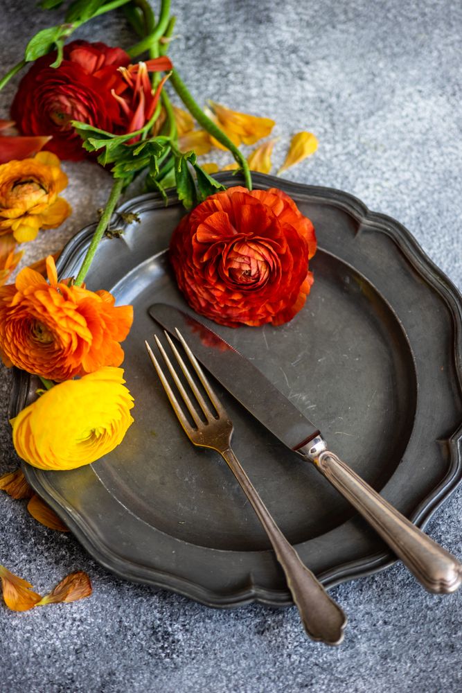 Rustic table setting with grey plate and fresh flowers