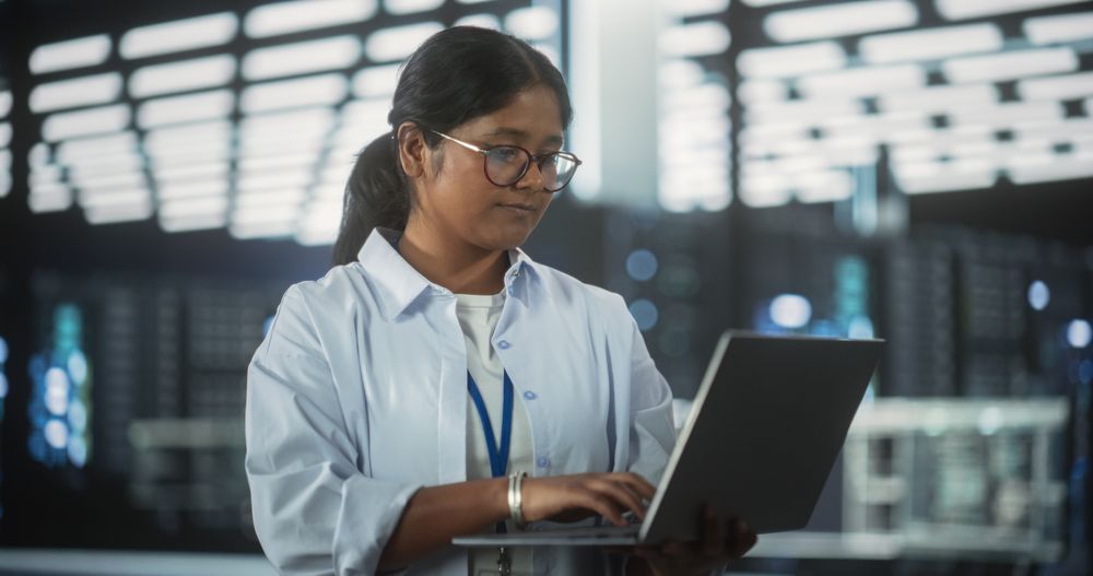 Indian Female Focused on Thinking while Working in the Office