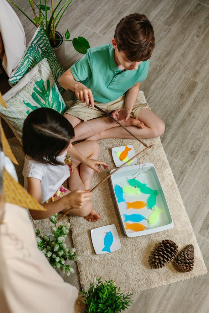Children playing fishing game at home