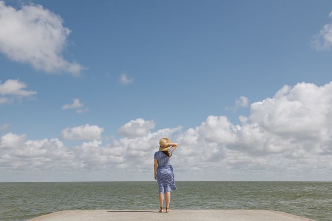 Young woman on sea wharf