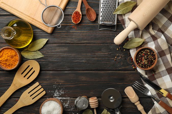 Composition with different kitchen cutlery on wooden background, space for text