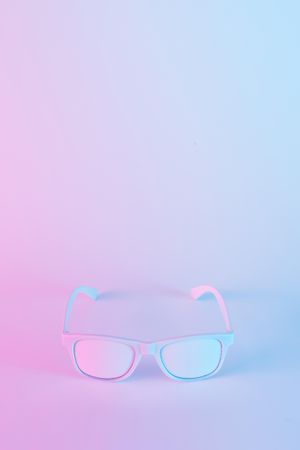 Sunglasses in vibrant bold gradient purple and blue holographic colors