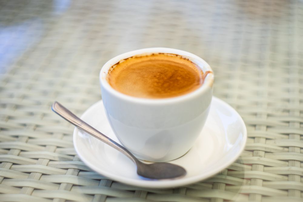 Cup of espresso with stirring spoon