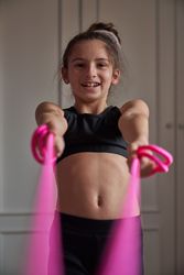 Happy girl with jumping rope at home