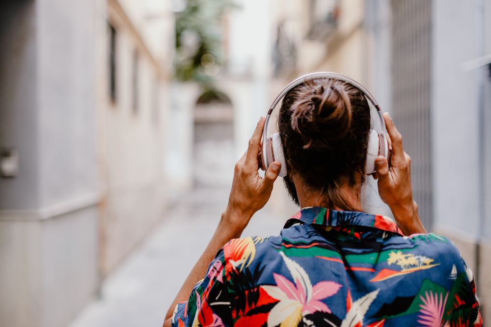 Modern male listening to music on street