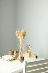 Work table with yarn, notebooks, pencils and chair, vertical