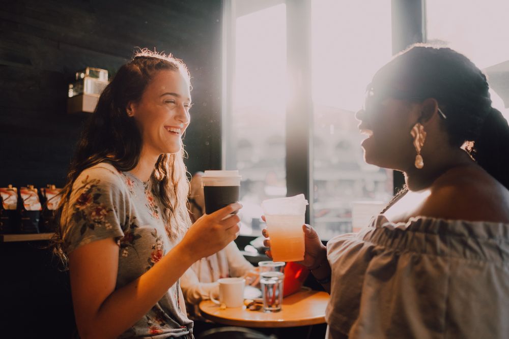 Multiethnic modern women relaxing at coffee shop