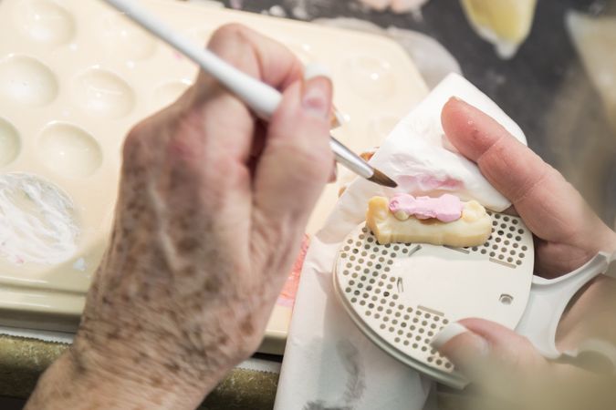 Dental Technician Applying Porcelain To 3D Printed Implant Mold