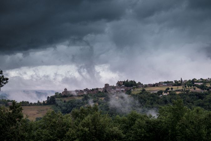 Low clouds over a medieval castle in the French countryside
