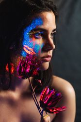 Young woman covered with uv painting
