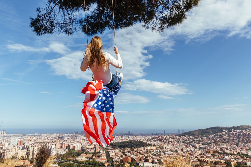 Female with flag on swing