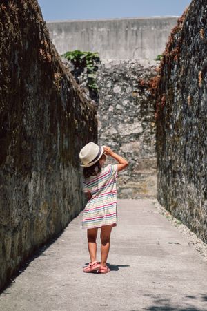 Girl in narrow stone walkway