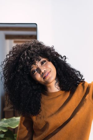Smiling Black woman with curly hair