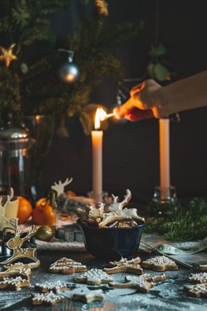Festive table setup with candles, cookies and greenery