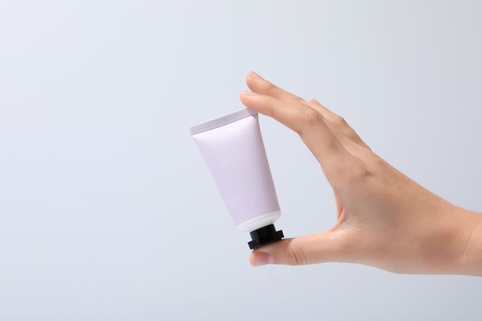 A jar of hand cream on a light background.