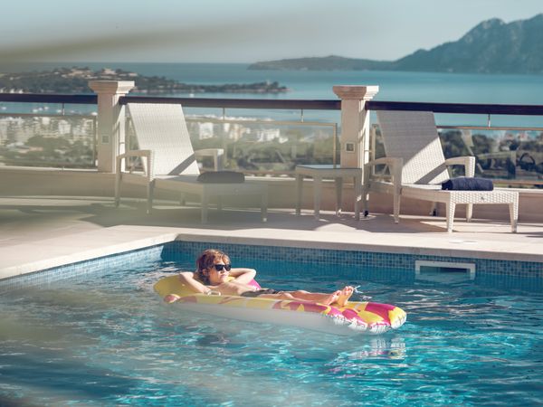 Boy resting in hotel swimming pool
