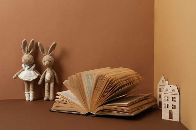 A children's book with toys on a beige background.