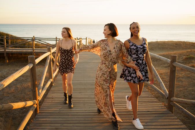Three woman walking on coastal pedestrian walkway
