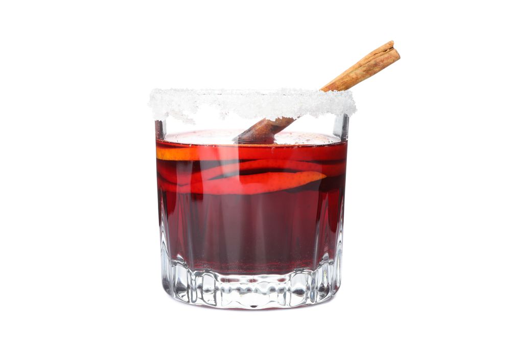 Glass of tasty mulled wine isolated on studio background