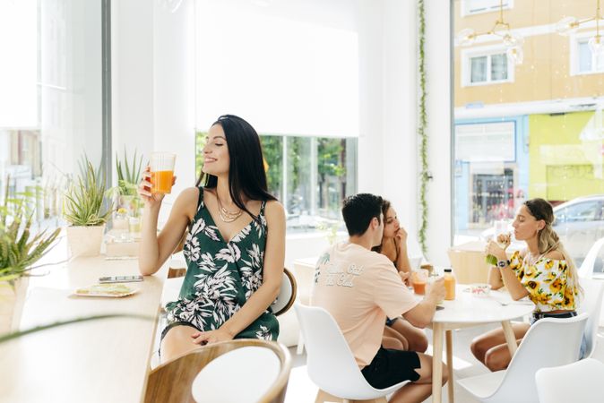 Woman with healthy drink sitting in cafe