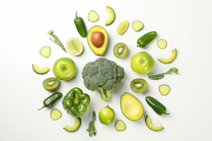 Green vegetables and fruits on blank background