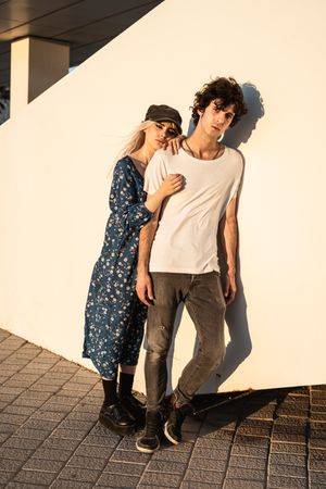 Couple leaning on wall contemplating