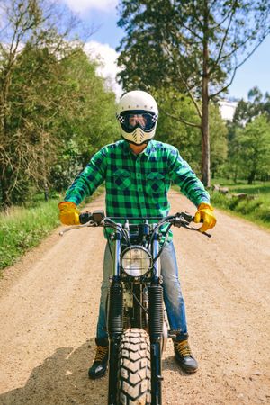 Man with helmet riding custom motorbike