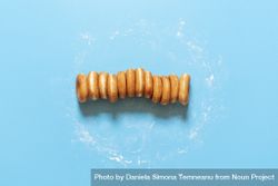 Donuts in a row on blue background 4OLGjb