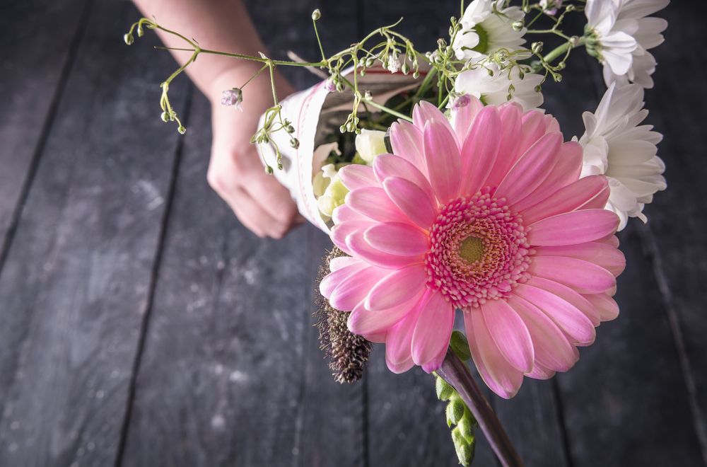Bouquet of flowers held in unrecognizable hand