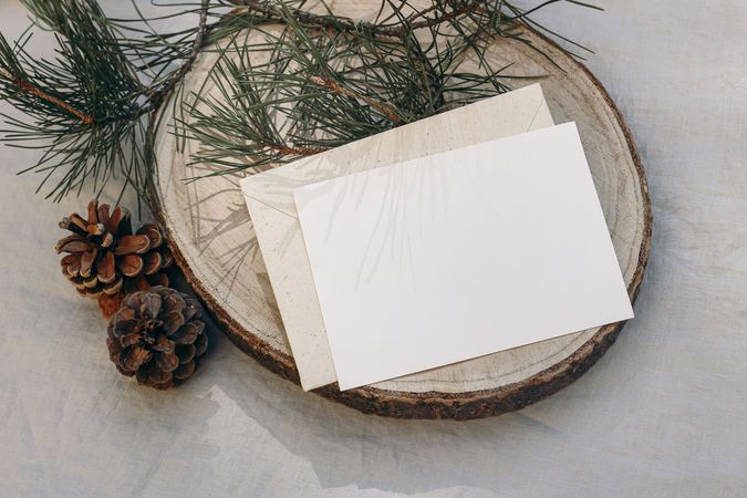 Blank greeting card, invitation mockup on cut wooden round board
