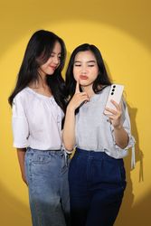 Two Generation Z Girl Taking Selfie Together using Smartphone