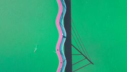 Minimal drone photo of a funky looking bridge