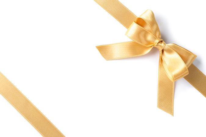 Golden ribbons with bow isolated on blank background. Gift concept