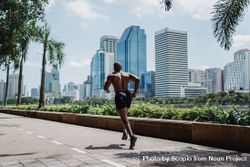 Topless man jogging on the road in the city 56d3Pb