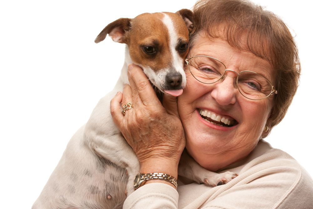 Happy Older Woman with Puppy on White