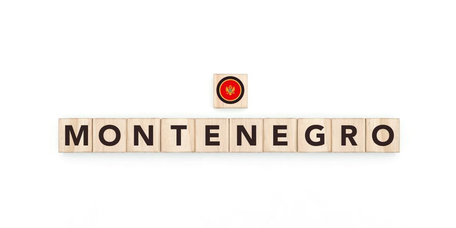 Wooden blocks bearing the name and flag of Montenegro. Montenegrin and European Culture, national identity, travel, and geography in a copy space design.