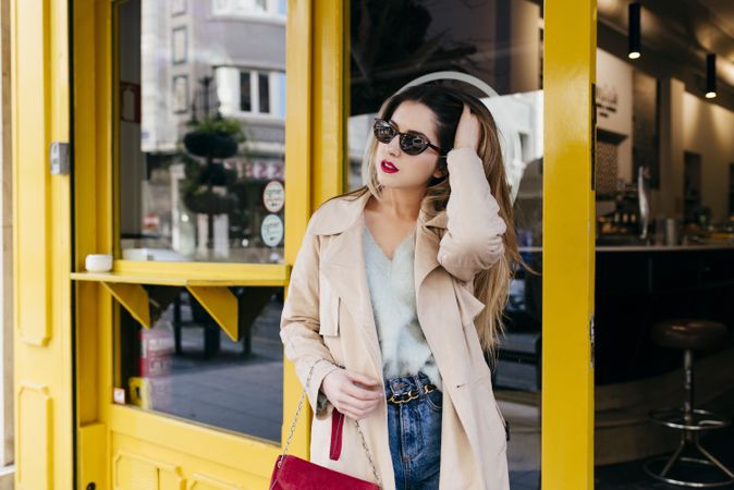 Young trendy female standing near bar
