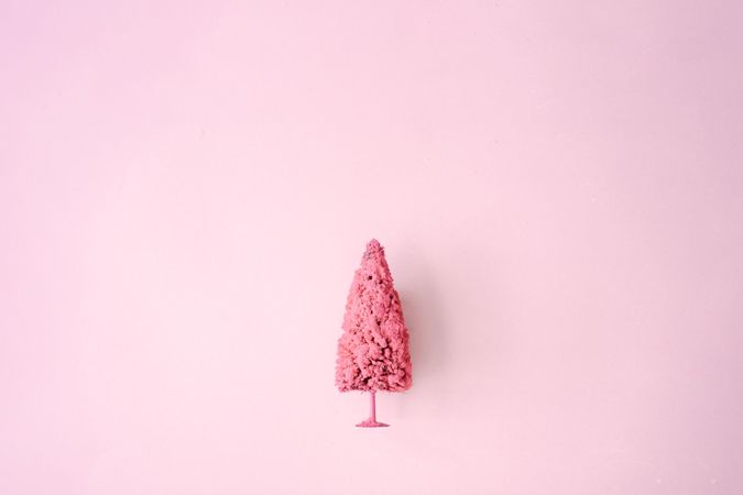 Light pink Christmas tree against pastel background
