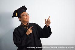 Excited male graduate in studio shoot 0KMyXY