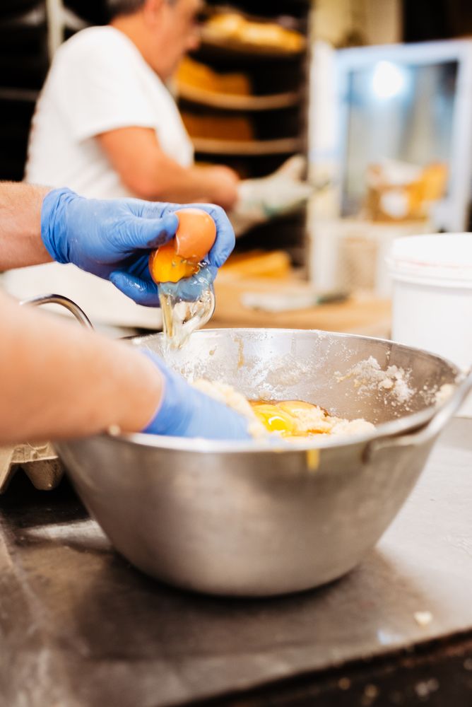 Unrecognizable bakery employee mixing dough