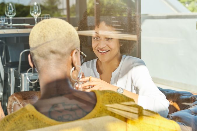 Happy diverse women enjoying meeting in cafe
