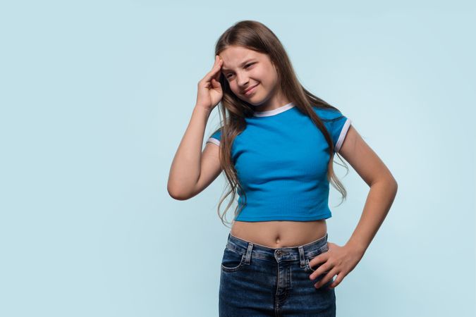 Girl holding head, showing signs of headache or stress