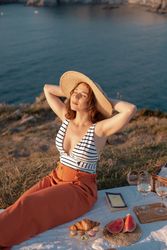 Woman resting in meadow on picnic