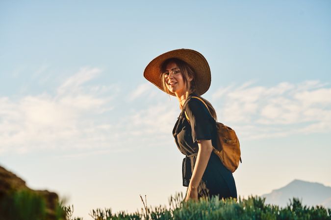 Woman traveler in straw hat walking