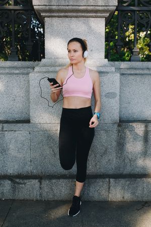 Woman with sportswear listening to music with headphones