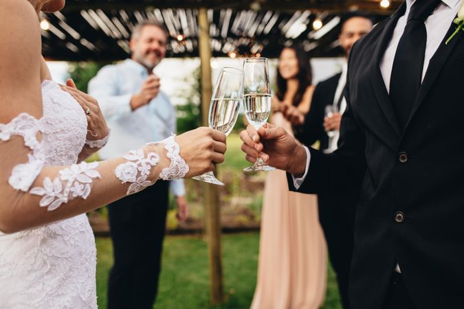 Close up of newlywed couple having drinks at wedding party